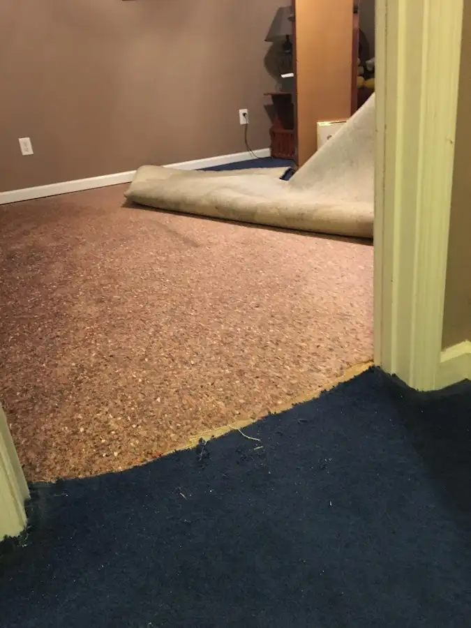 Carpet pad removal revealing water damage during Water Mitigation Services in Pewaukee